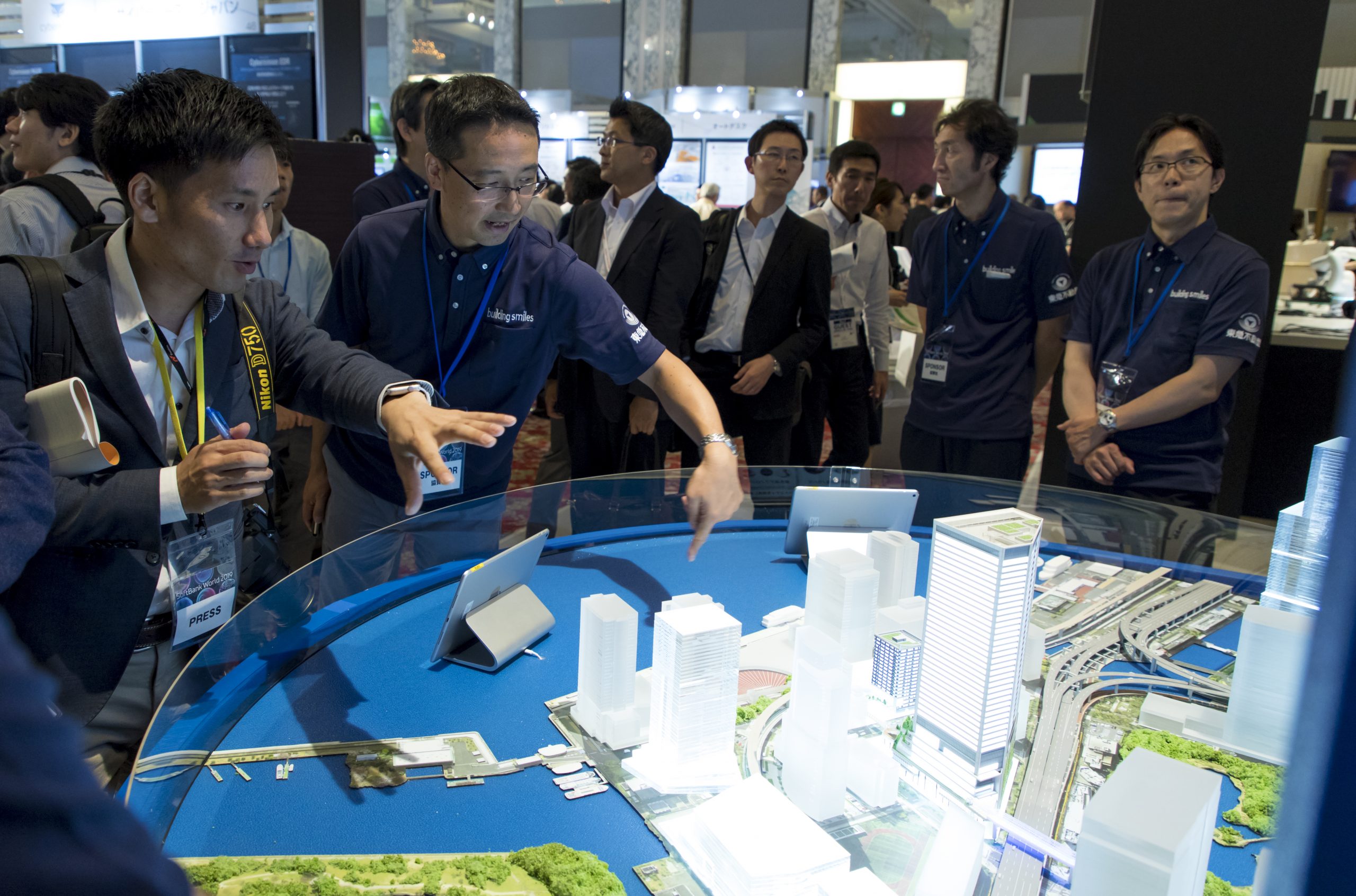 People looking at map of new SoftBank headquarters in Tokyo at SoftBank World 2019