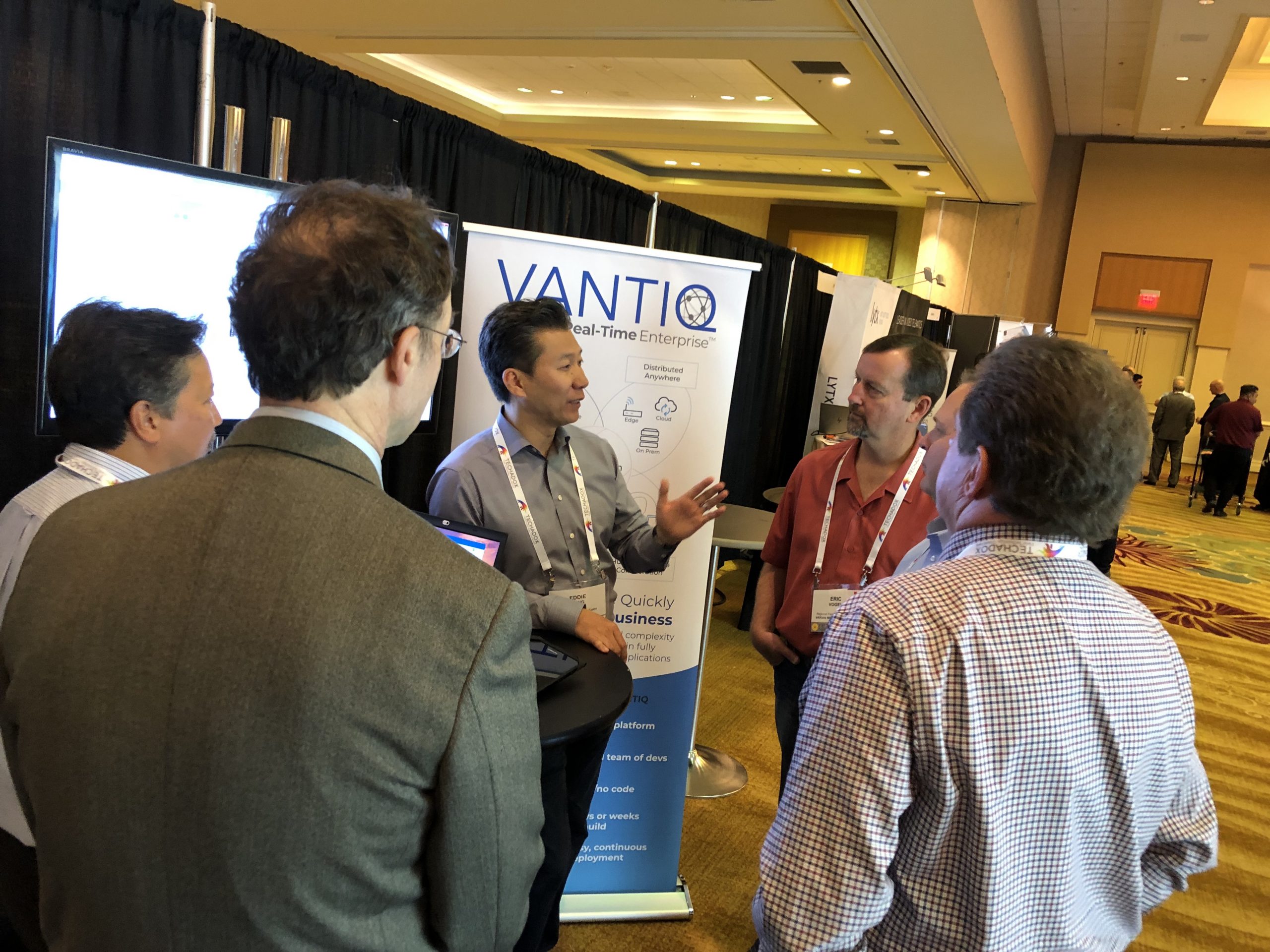 Eddie Tung, Mark Silva and Robert Biczek talking to other participants at VANTIQ booth