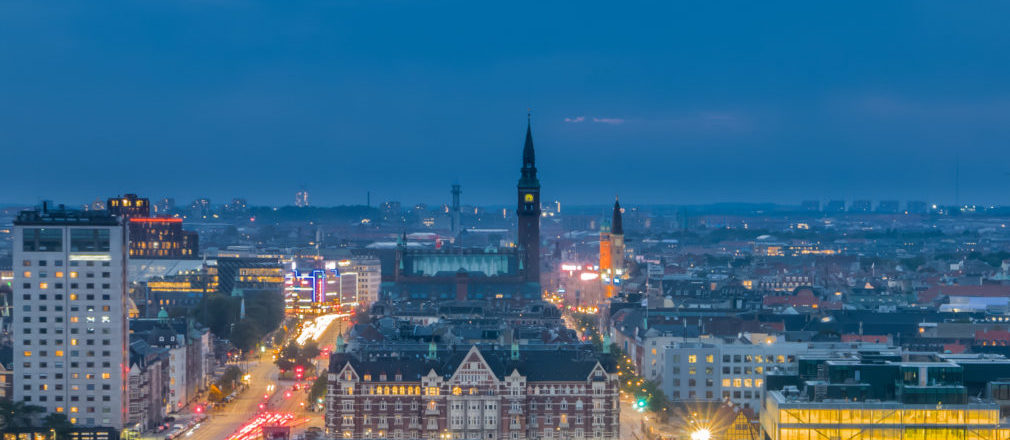 city scape at night with clock tower in middle