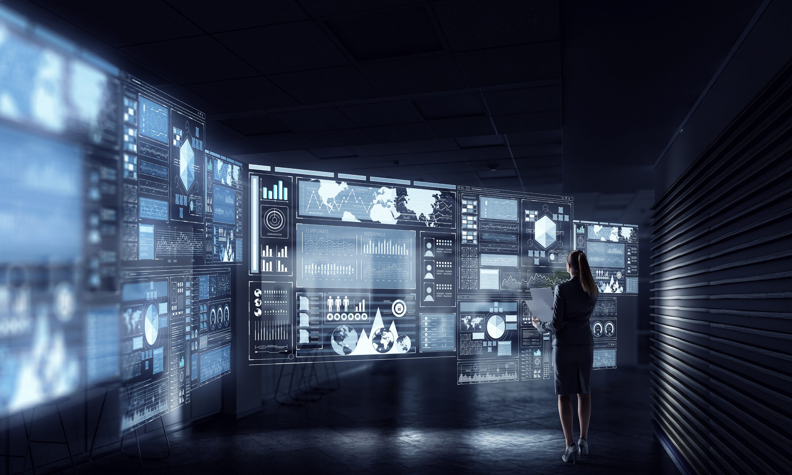 woman standing in front of digital business technology platform dashboard